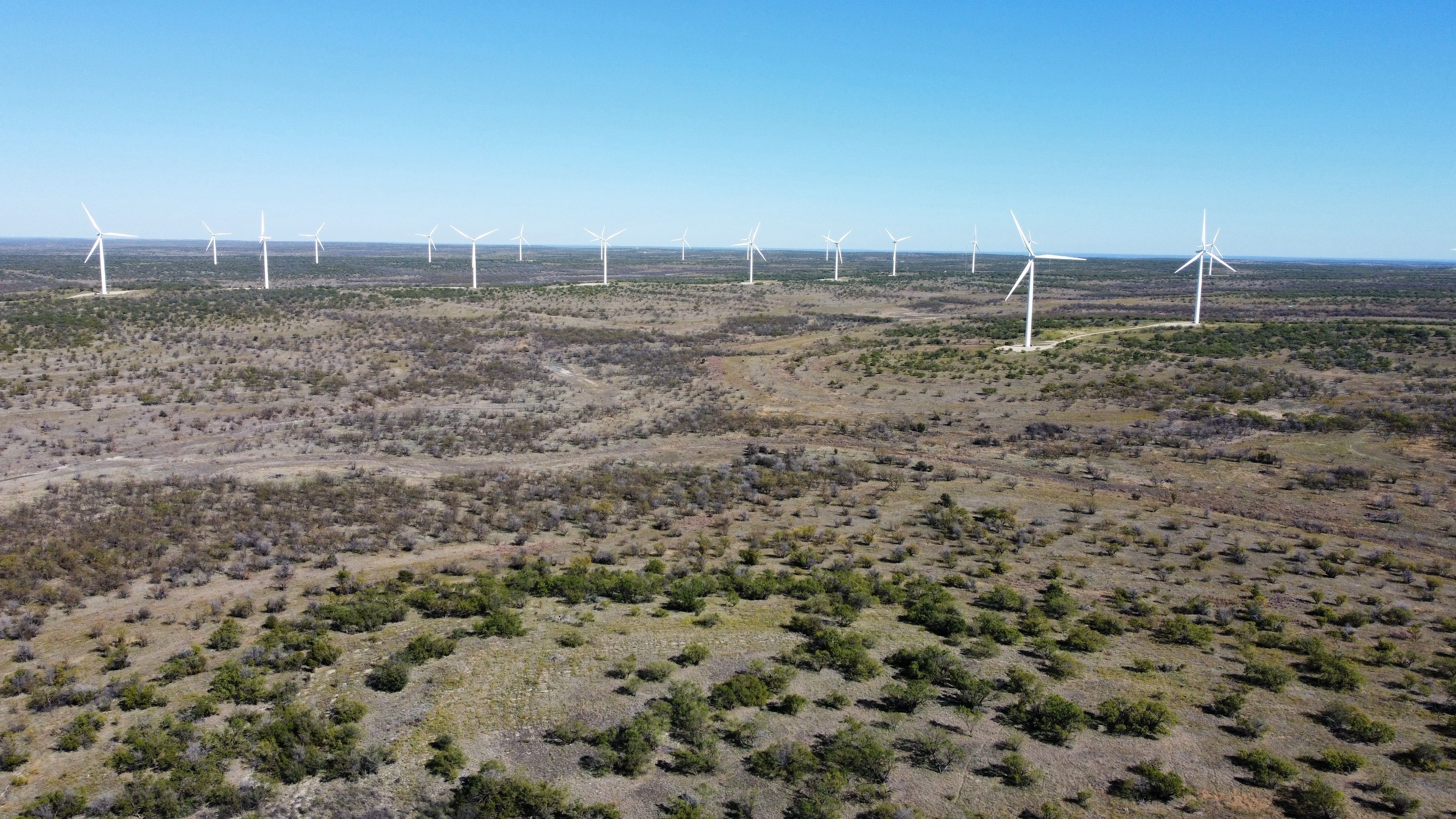 Aerial view of Hackberry Wind Farm in Shackleford County, Texas, showing refurbished turbines generating clean energy across open prairie landscape.